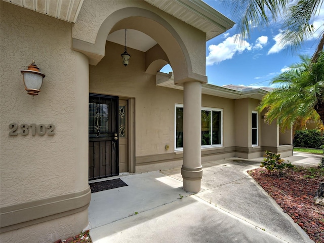 23102 Madelyn Ave, Port Charlotte, FL 33954 - entrance to property with stucco siding and a patio area