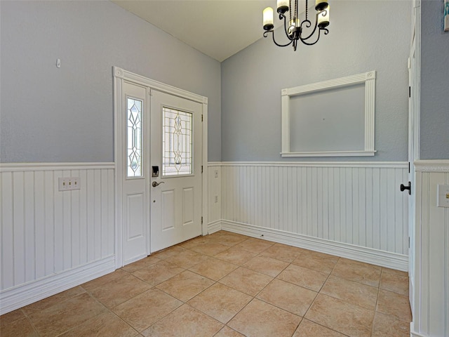 23102 Madelyn Ave, Port Charlotte, FL 33954 - entryway with a chandelier, wainscoting, and light tile patterned floors