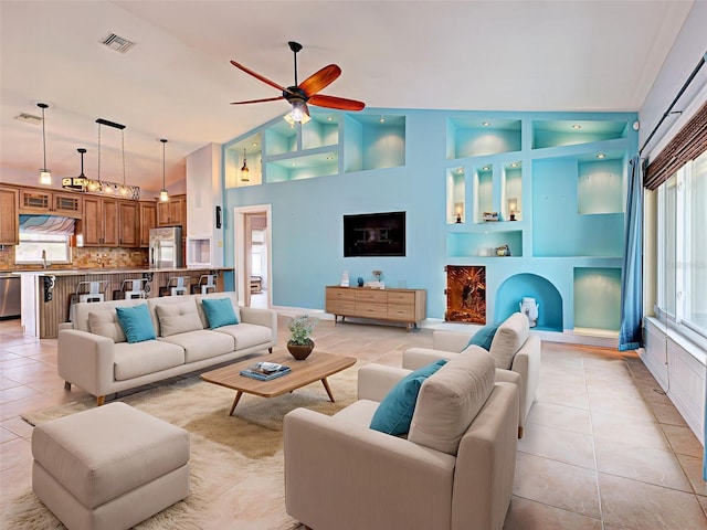 23102 Madelyn Ave, Port Charlotte, FL 33954 - living area featuring ceiling fan, light tile patterned floors, built in shelves, and high vaulted ceiling