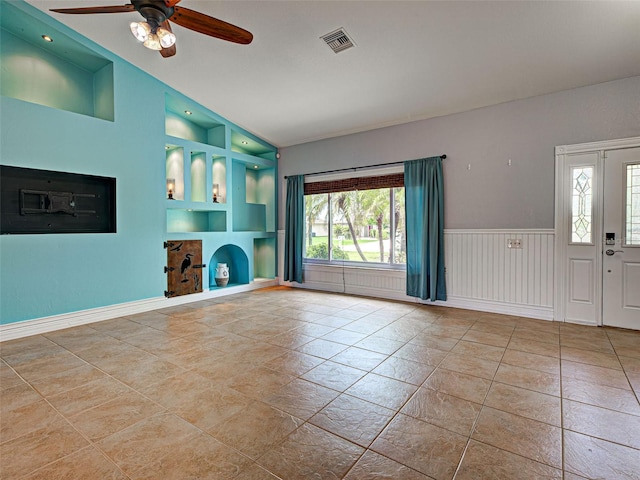 23102 Madelyn Ave, Port Charlotte, FL 33954 - unfurnished living room with built in features, a ceiling fan, vaulted ceiling, a fireplace with raised hearth, and tile patterned flooring
