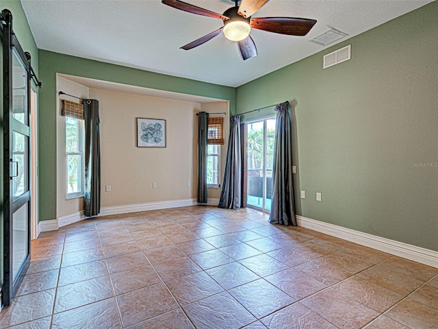 23102 Madelyn Ave, Port Charlotte, FL 33954 - spare room featuring a ceiling fan, a textured ceiling, and a textured wall
