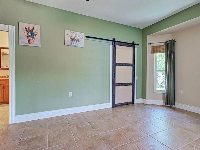 23102 Madelyn Ave, Port Charlotte, FL 33954 - unfurnished room with a barn door and tile patterned floors