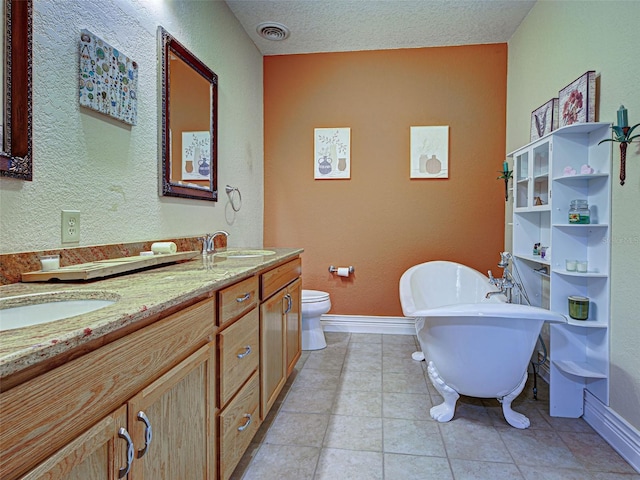23102 Madelyn Ave, Port Charlotte, FL 33954 - bathroom featuring a soaking tub, double vanity, a textured wall, and tile patterned flooring