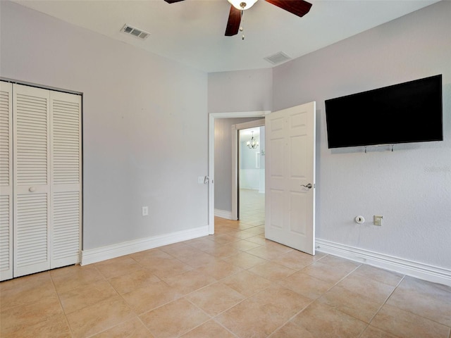 23102 Madelyn Ave, Port Charlotte, FL 33954 - unfurnished bedroom with light tile patterned floors, ceiling fan, and a closet