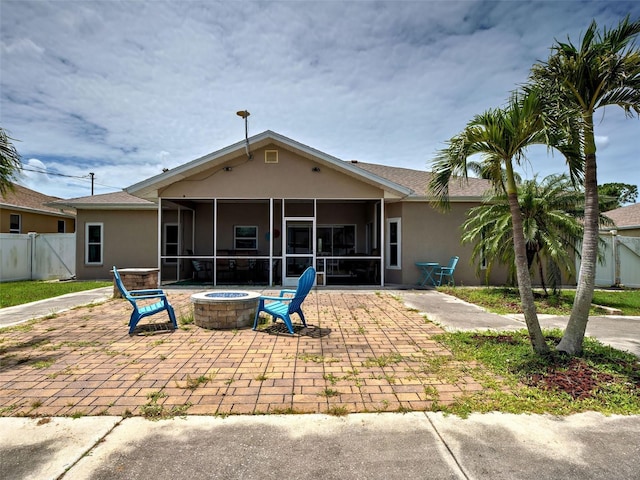 23102 Madelyn Ave, Port Charlotte, FL 33954 - rear view of house featuring a sunroom, stucco siding, a patio area, and a fire pit
