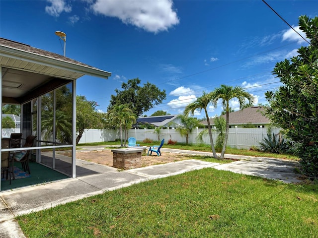 23102 Madelyn Ave, Port Charlotte, FL 33954 - fenced backyard featuring a patio, a fire pit, and a sunroom