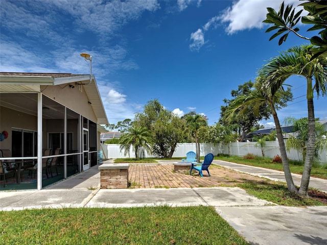 23102 Madelyn Ave, Port Charlotte, FL 33954 - view of yard featuring an outdoor fire pit, a sunroom, and a patio