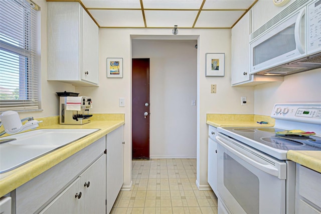 244 Saint Augustine Ave Unit 202, Venice, FL 34285 - kitchen with white appliances, light countertops, and white cabinets