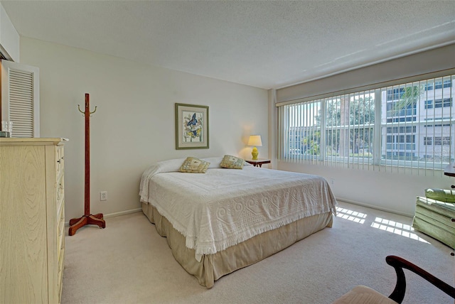 244 Saint Augustine Ave Unit 202, Venice, FL 34285 - bedroom with light carpet and a textured ceiling