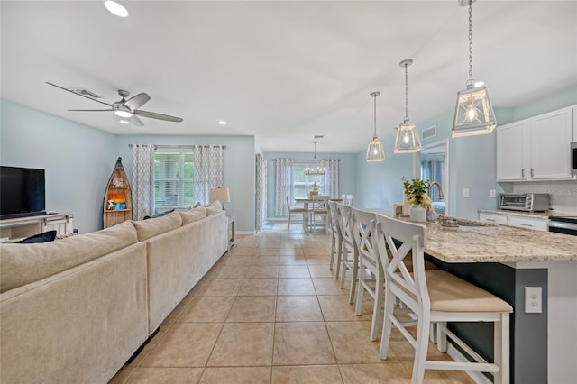 7164 Mikasa Dr, Punta Gorda, FL 33950 - living room featuring ceiling fan, recessed lighting, and light tile patterned floors