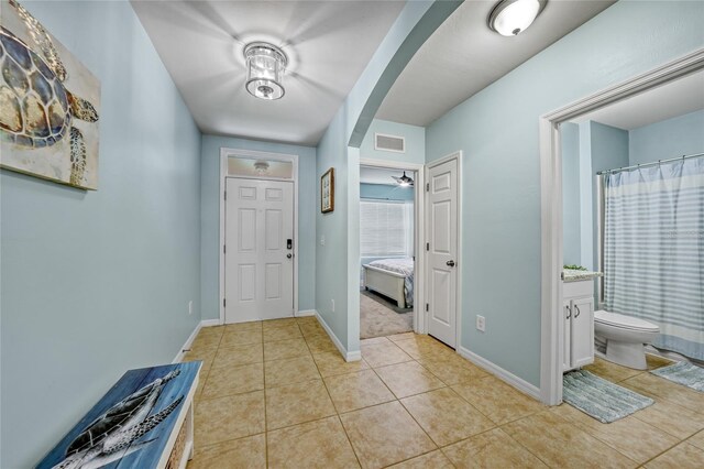 7164 Mikasa Dr, Punta Gorda, FL 33950 - entryway featuring light tile patterned floors and arched walkways