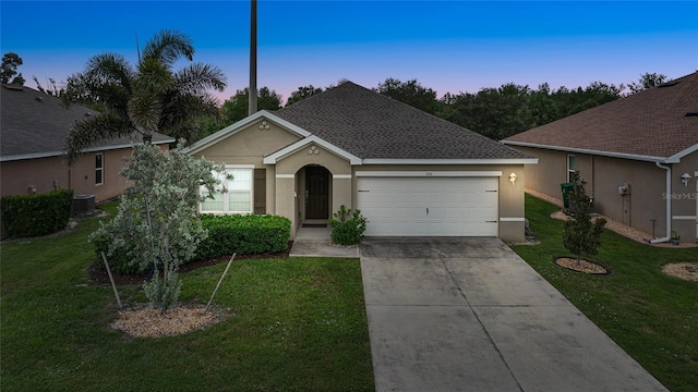 7164 Mikasa Dr, Punta Gorda, FL 33950 - view of front of property with stucco siding, a garage, driveway, and a yard