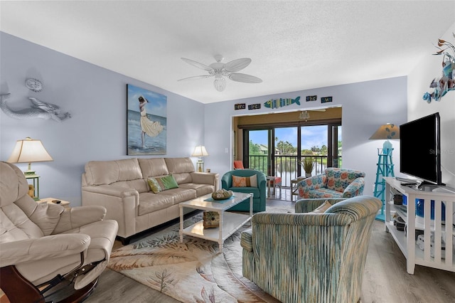 340 Three Lakes Ln Unit F, Venice, FL 34285 - living room with wood finished floors, a ceiling fan, and a textured ceiling