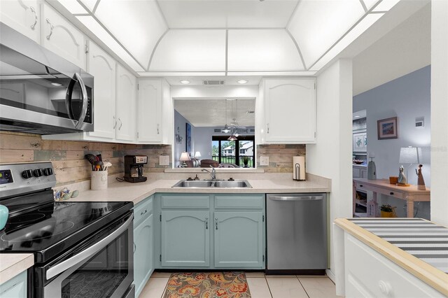 340 Three Lakes Ln Unit F, Venice, FL 34285 - kitchen featuring stainless steel appliances, light countertops, tasteful backsplash, and white cabinetry
