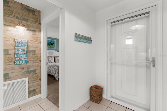340 Three Lakes Ln Unit F, Venice, FL 34285 - hall with wooden walls and light tile patterned floors