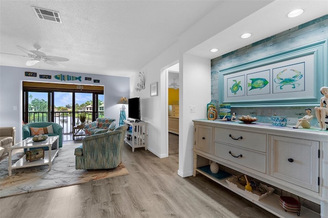 340 Three Lakes Ln Unit F, Venice, FL 34285 - living area with a ceiling fan, light wood finished floors, a textured ceiling, and recessed lighting