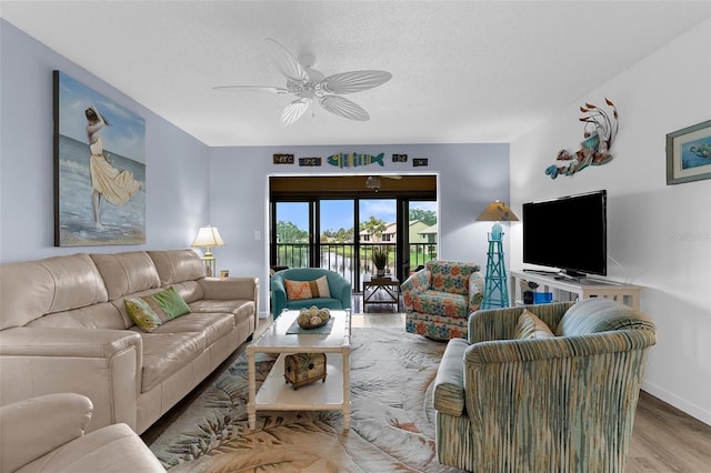 340 Three Lakes Ln Unit F, Venice, FL 34285 - living area featuring wood finished floors, a ceiling fan, and a textured ceiling