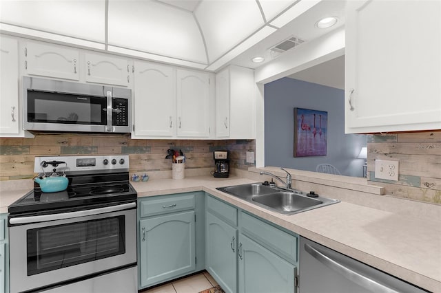 340 Three Lakes Ln Unit F, Venice, FL 34285 - kitchen featuring appliances with stainless steel finishes, light countertops, white cabinets, backsplash, and recessed lighting