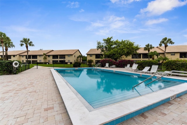 340 Three Lakes Ln Unit F, Venice, FL 34285 - community pool featuring a residential view and a patio area