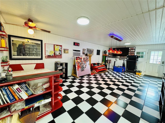 6522 Pimlico St, North Port, FL 34291 - playroom with tile patterned floors, wood ceiling, a ceiling fan, and wooden walls