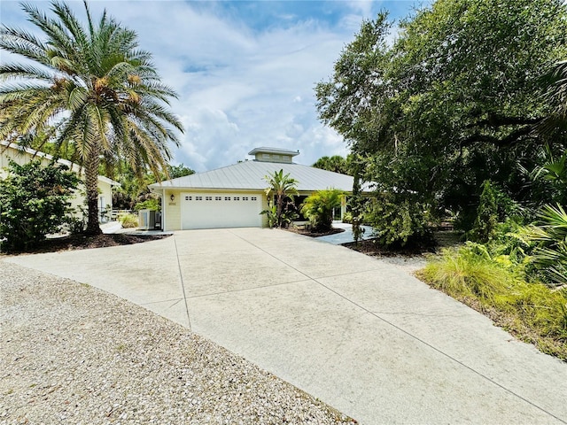 6522 Pimlico St, North Port, FL 34291 - view of front facade featuring driveway, an attached garage, and a metal roof