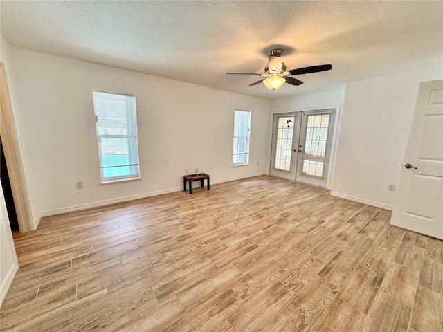 6522 Pimlico St, North Port, FL 34291 - unfurnished room featuring french doors, a textured ceiling, healthy amount of natural light, and light wood finished floors