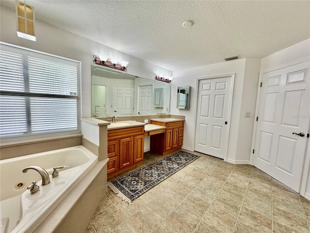 6522 Pimlico St, North Port, FL 34291 - full bath with double vanity, a bath, and a textured ceiling