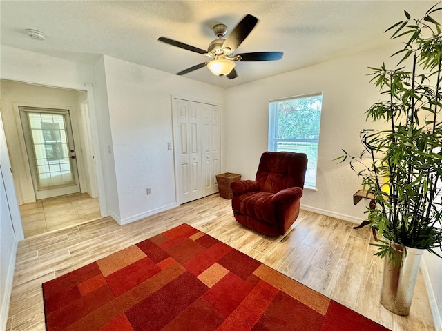 6522 Pimlico St, North Port, FL 34291 - living area with wood finished floors, a ceiling fan, and a textured ceiling