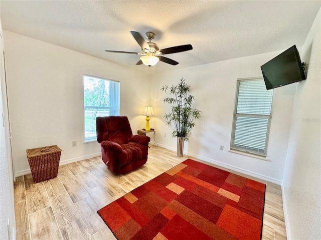 6522 Pimlico St, North Port, FL 34291 - sitting room with wood finished floors, a ceiling fan, and a textured ceiling