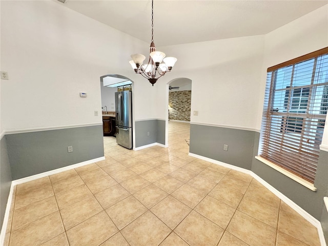 6522 Pimlico St, North Port, FL 34291 - spare room with arched walkways, light tile patterned flooring, and a chandelier