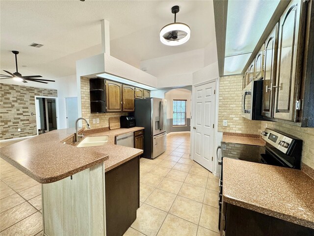 6522 Pimlico St, North Port, FL 34291 - kitchen with appliances with stainless steel finishes, tasteful backsplash, light tile patterned floors, a peninsula, and ceiling fan