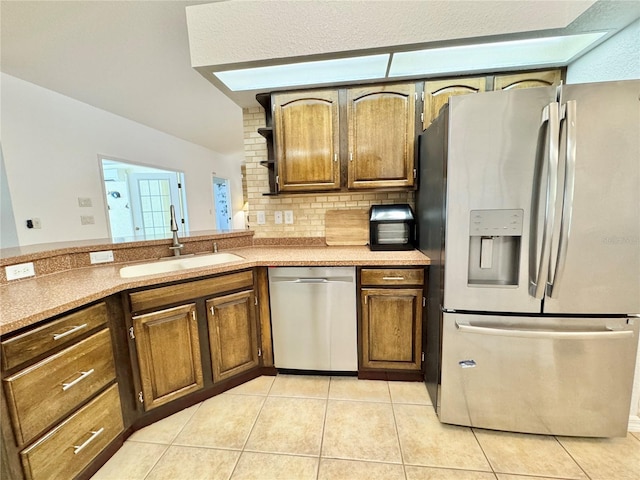 6522 Pimlico St, North Port, FL 34291 - kitchen featuring appliances with stainless steel finishes, light tile patterned floors, decorative backsplash, and light countertops