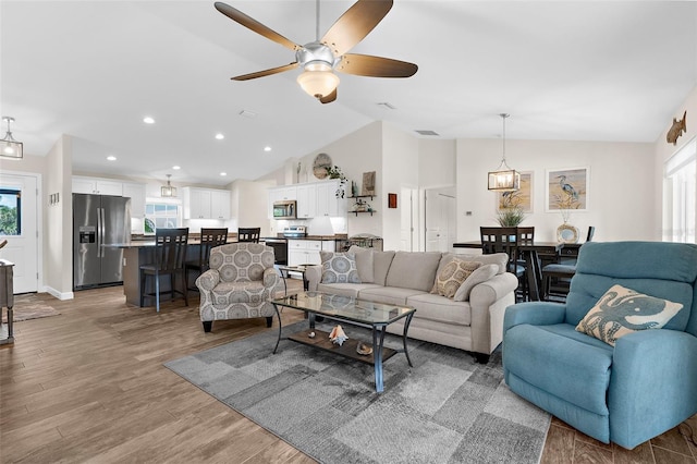 108 Albatross Rd, Rotonda West, FL 33947 - living area featuring vaulted ceiling, healthy amount of natural light, wood finished floors, ceiling fan, and recessed lighting