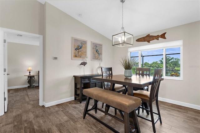 108 Albatross Rd, Rotonda West, FL 33947 - dining room featuring dark wood-type flooring, lofted ceiling, and a chandelier