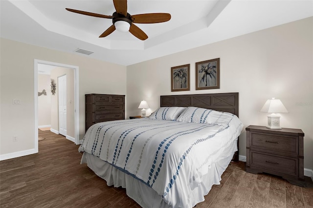 108 Albatross Rd, Rotonda West, FL 33947 - bedroom featuring a tray ceiling, wood finished floors, and a ceiling fan