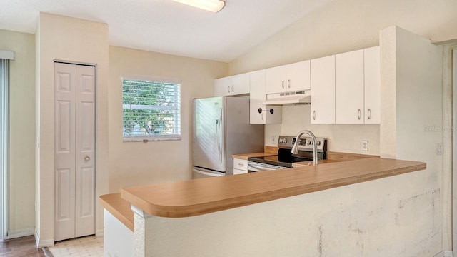 2403 Trianna St, North Port, FL 34291 - kitchen featuring stainless steel appliances, under cabinet range hood, light countertops, vaulted ceiling, and white cabinetry