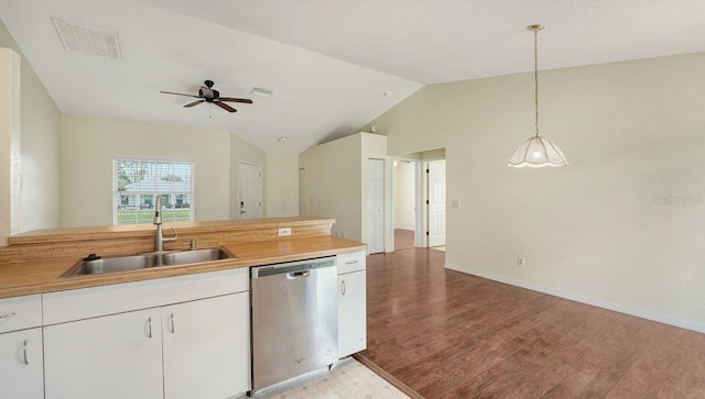 2403 Trianna St, North Port, FL 34291 - kitchen with dishwasher, light countertops, vaulted ceiling, a ceiling fan, and white cabinetry