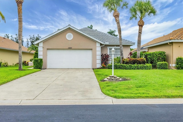 1429 Turnberry Dr, Venice, FL 34292 - view of front facade featuring stucco siding, concrete driveway, a front yard, and a garage