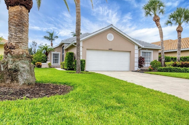 1429 Turnberry Dr, Venice, FL 34292 - view of front facade with stucco siding, a garage, a front yard, and concrete driveway