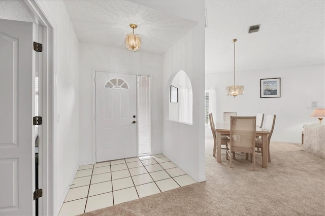 1429 Turnberry Dr, Venice, FL 34292 - entryway featuring a chandelier, light colored carpet, and arched walkways