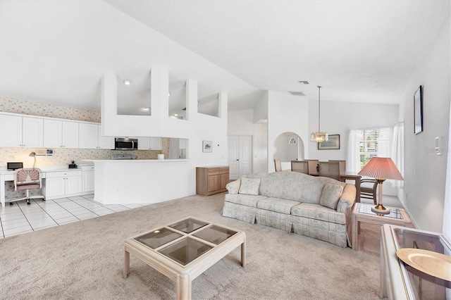 1429 Turnberry Dr, Venice, FL 34292 - living room with light colored carpet, high vaulted ceiling, and light tile patterned floors
