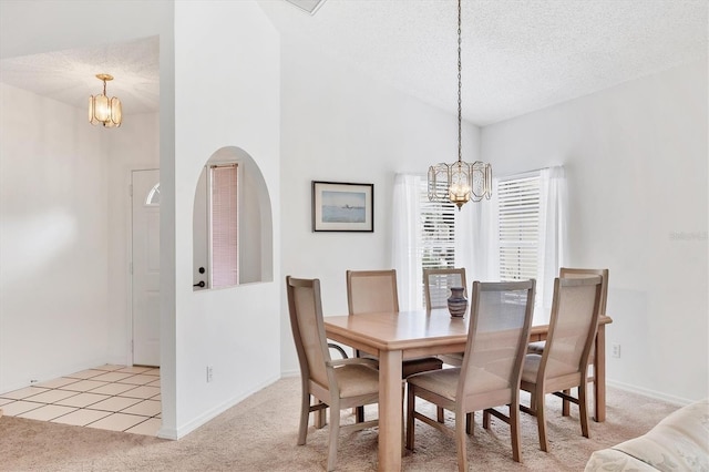 1429 Turnberry Dr, Venice, FL 34292 - carpeted dining space featuring a chandelier, a textured ceiling, and lofted ceiling