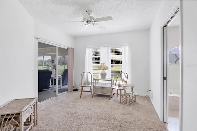 1429 Turnberry Dr, Venice, FL 34292 - living area featuring light colored carpet, a ceiling fan, and a textured ceiling