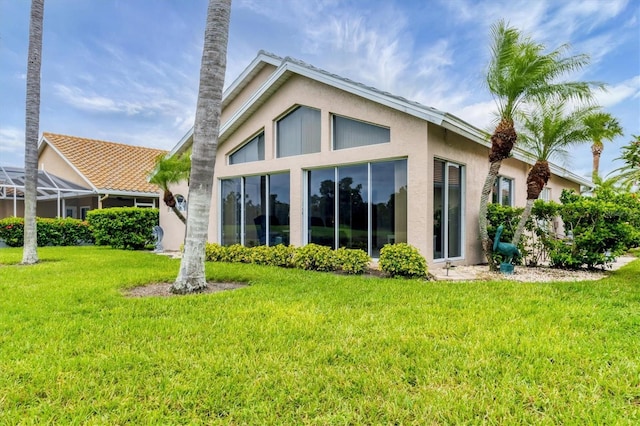 1429 Turnberry Dr, Venice, FL 34292 - rear view of property with stucco siding and a yard