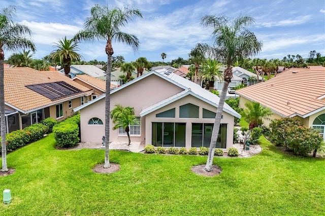 1429 Turnberry Dr, Venice, FL 34292 - rear view of property featuring stucco siding, a yard, and a residential view