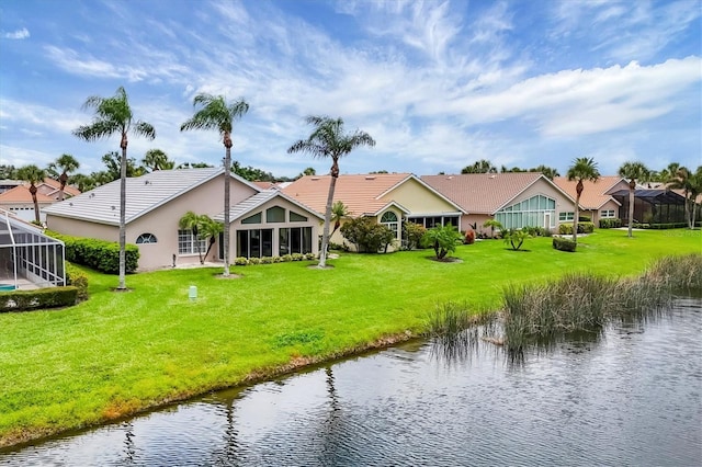 1429 Turnberry Dr, Venice, FL 34292 - rear view of house with a water view and a lawn