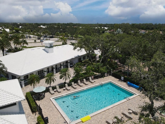 1429 Turnberry Dr, Venice, FL 34292 - community pool featuring a patio area and view of wooded area