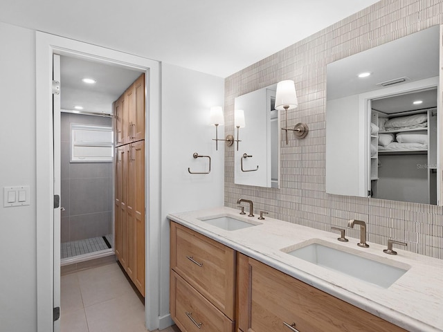6300 Midnight Pass Rd Unit 809, Sarasota, FL 34242 - bathroom with double vanity, tile patterned floors, a tile shower, tasteful backsplash, and tile walls