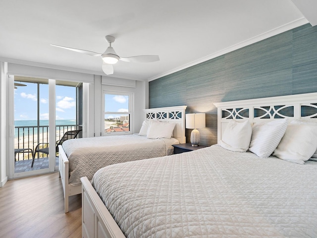 6300 Midnight Pass Rd Unit 809, Sarasota, FL 34242 - bedroom featuring access to exterior, light wood-style floors, a water view, a ceiling fan, and crown molding