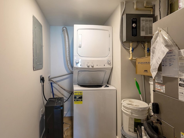 6300 Midnight Pass Rd Unit 809, Sarasota, FL 34242 - laundry room with stacked washer / dryer, electric panel, and water heater